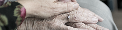 Elderly couple holding hands.